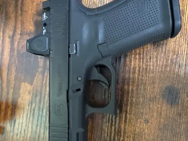 Glock 19 Gen 5 MOS with Trijicon red dot sight and suppressor height night sights